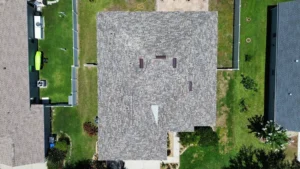 Aerial top view of a residential house roof showcasing roofing material, design, and clean installation by JAC Builders