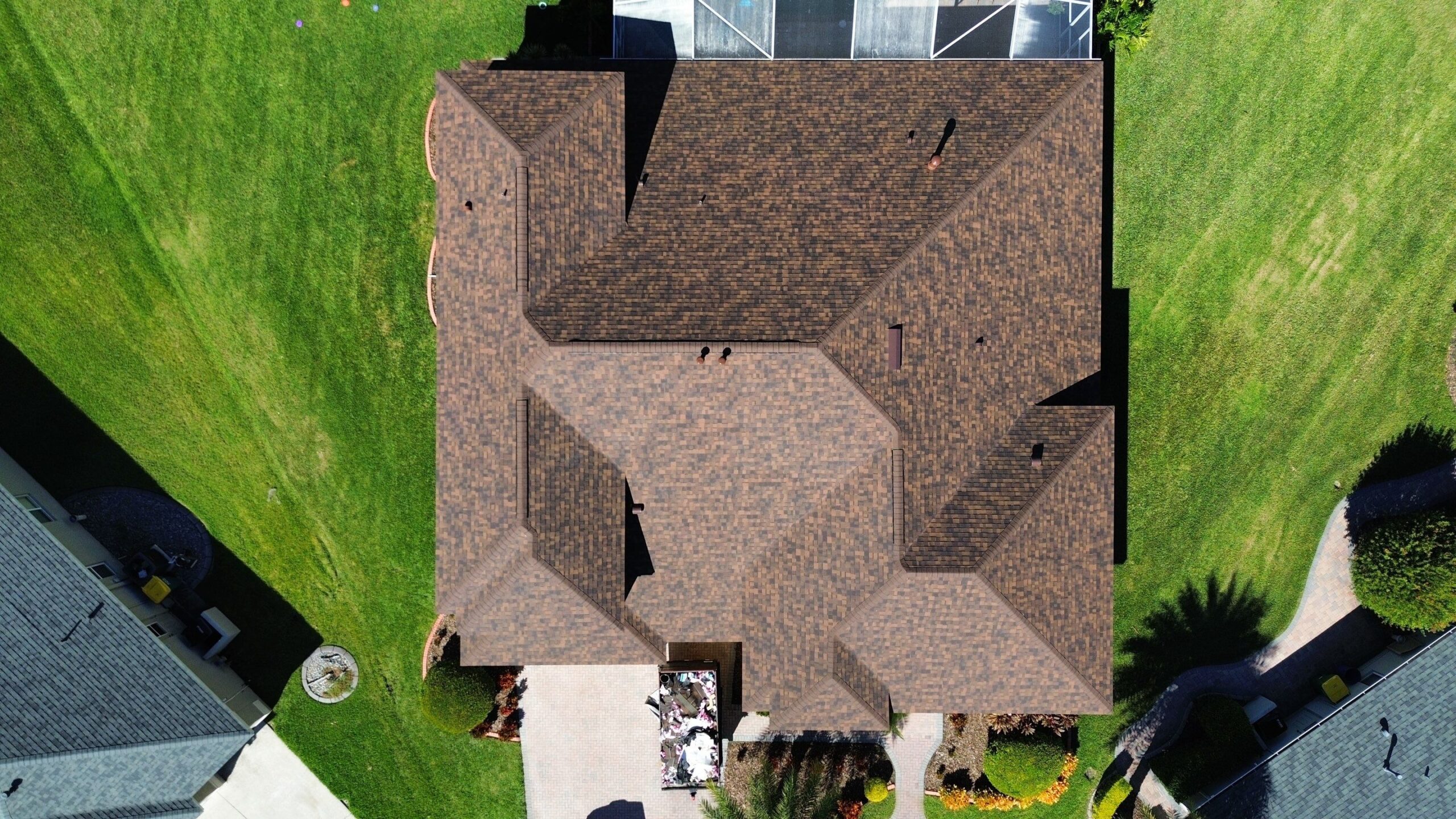 Wide view of a residential house roof with asphalt shingles, constructed by JAC Builders
